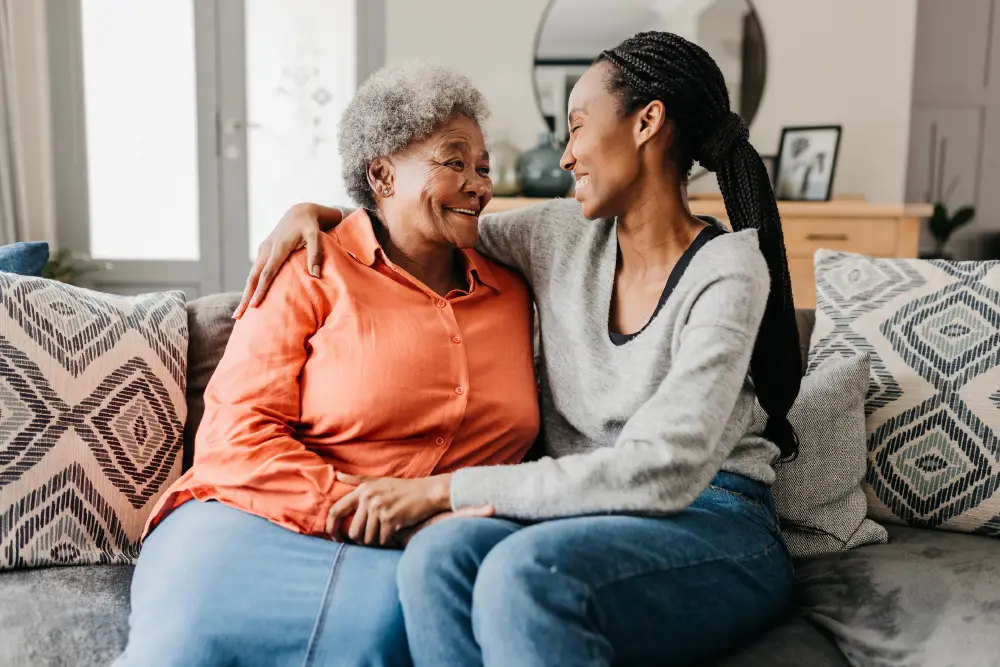 a smiling woman with her arm around her senior mother