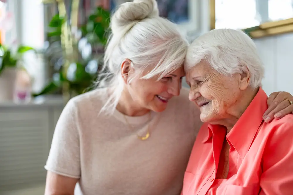 a smiling woman with her arm around her senior mother
